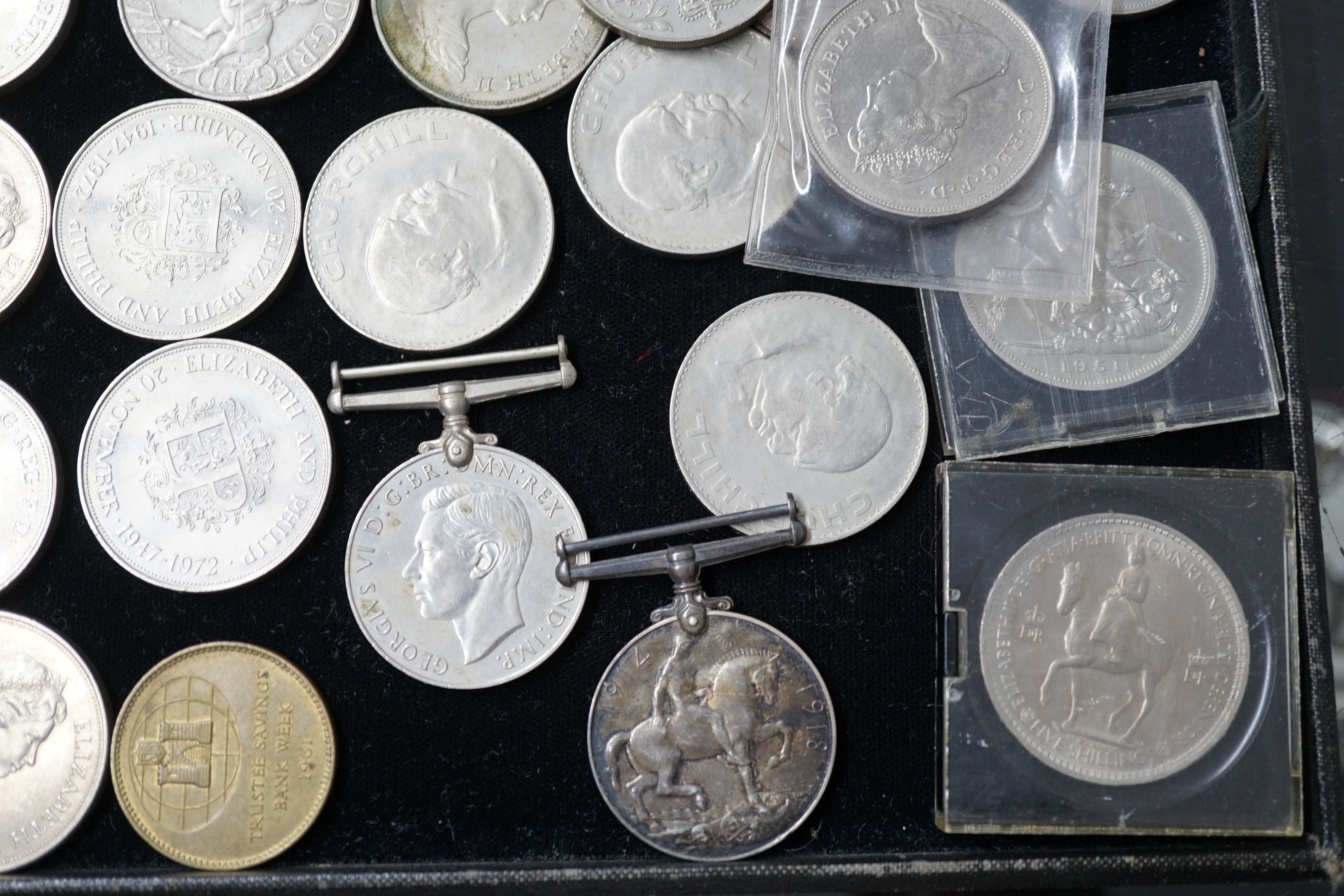 A group of QEII crowns and two medals